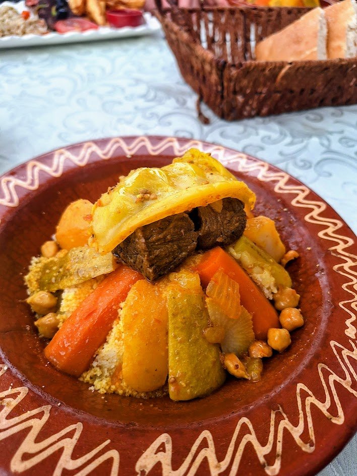 Couscous with seven vegetables and beef in a clay dish